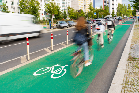 Group of bike riders commuting on a bicycle lane in the c