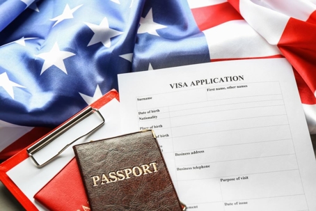 Visa Application and Passport on top of American Flag