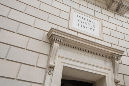 Closeup of the IRS sign seen at one of the entrances to the Internal Revenue Service (IRS) Building in Washington, DC.